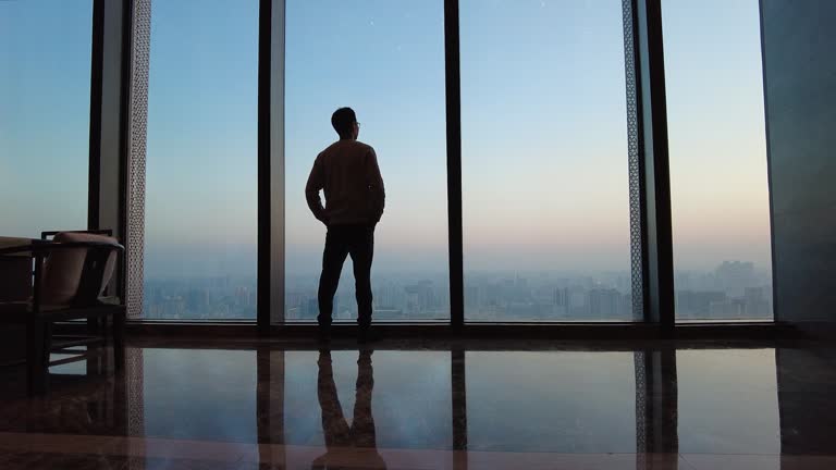 A person walking near a bright office window during a short break